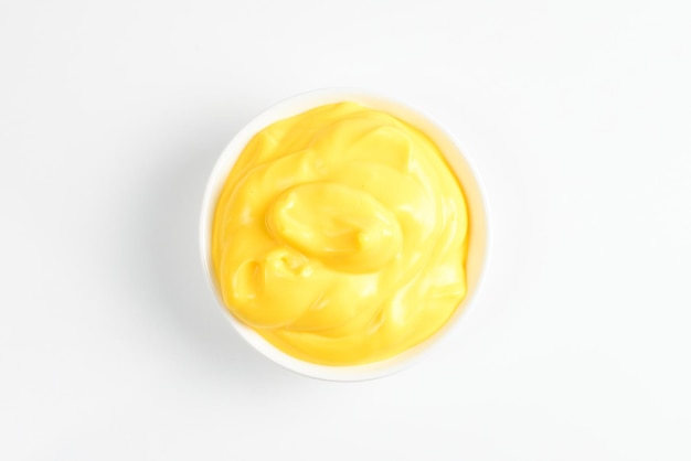 Cheese sauce in white plate on white background.