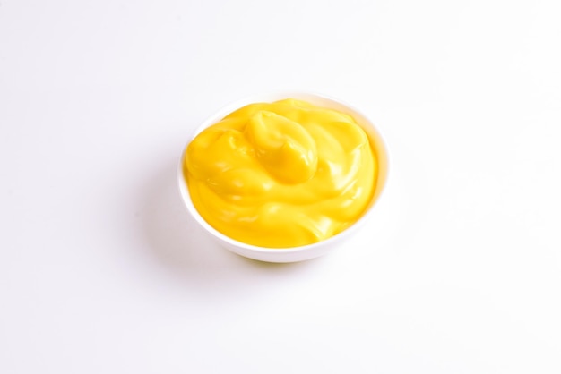 Cheese sauce in white plate on white background