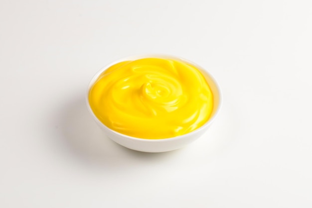 Cheese sauce in white plate on white background