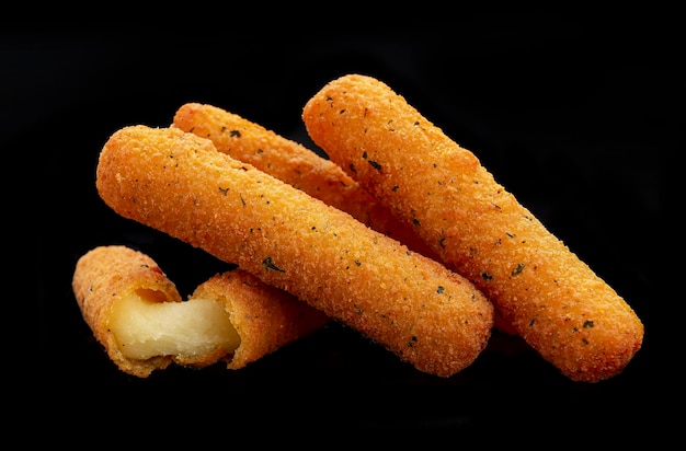 Cheese sticks on the black background