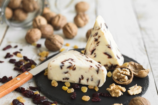 Cheese with cranberry served with walnut dried cranberry and yellow raisin