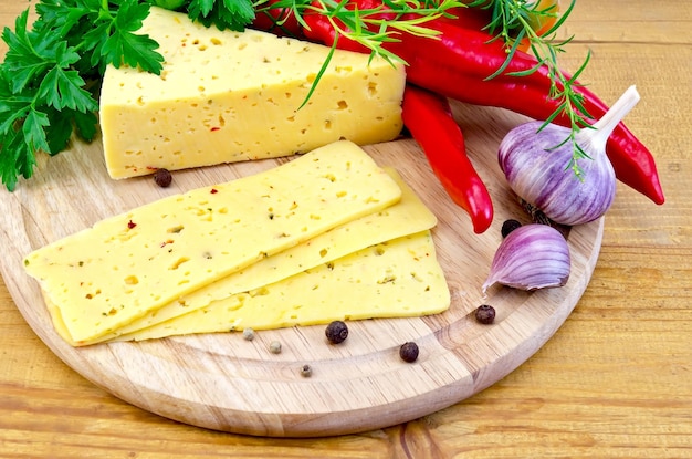 Cheese with spices and herbs on a round board