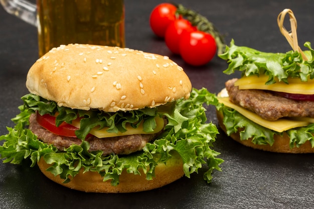 Cheeseburger with greens on bun with sesame seeds