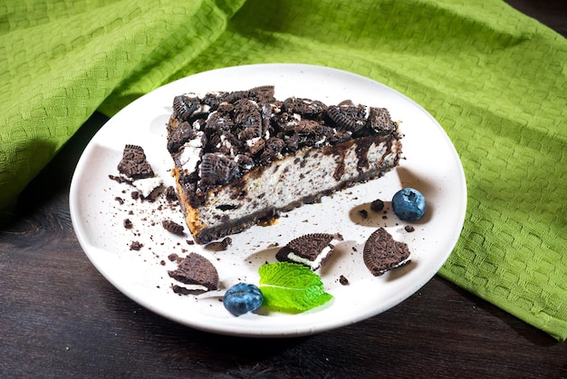 Cheesecake with brown cookies blueberries and mint