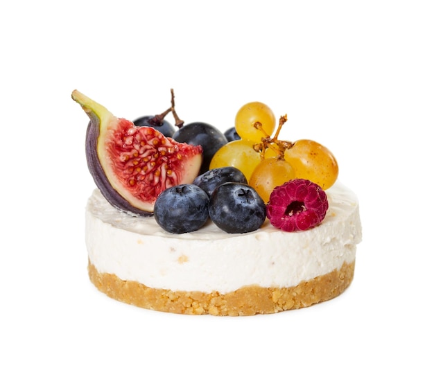 Cheesecake with figs grapes blueberries and raspberries isolated on white background