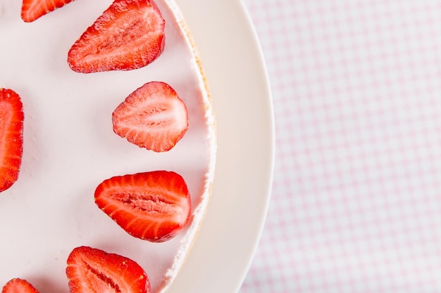 Cheesecake with strawberries and mint on a table with a light tablecloth Sweet homemade breakfast Copy space