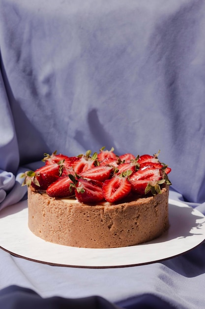 Cheesecake with strawberries on a purple background Appetizing beautiful cake Bright presentation