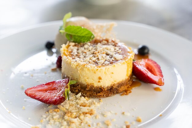 Cheesecake with toffee coconut milk, ginger cookies and strawberries. Gourmet food, sweet dessert