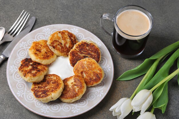 Cheesecakes and a Cup of coffee and white tulips