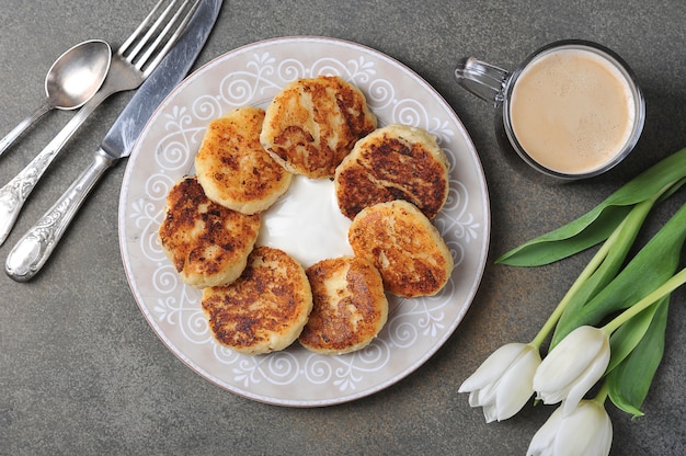 Cheesecakes and a Cup of coffee and white tulips