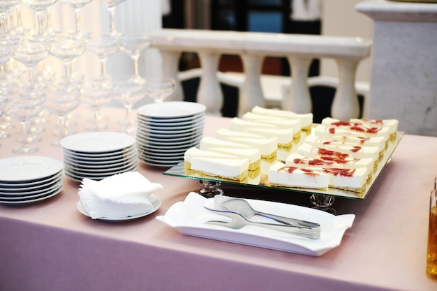 Cheesecakes with different flavors on a mirrored tray on the buffet table