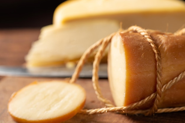 Cheeses scene with different cheeses and accessories over rustic wood selective focus