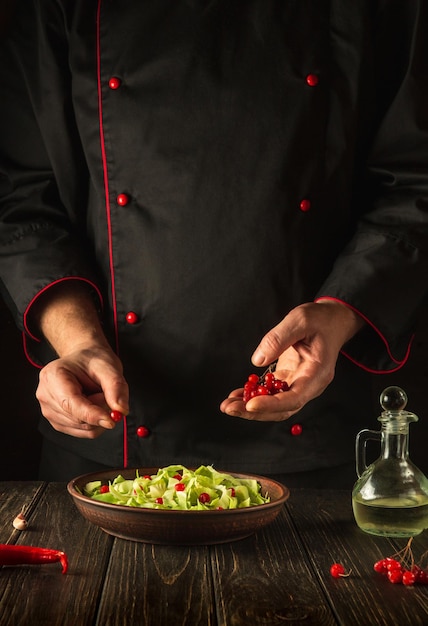 The chef adds viburnum to a salad of fresh vegetables