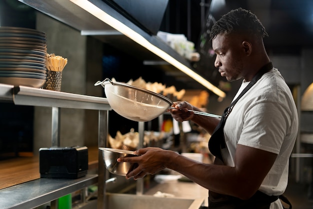 Chef cooking in the kitchen while wearing professional attire