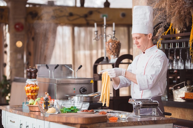 Chef cooks spaghetti in a premium restaurant.