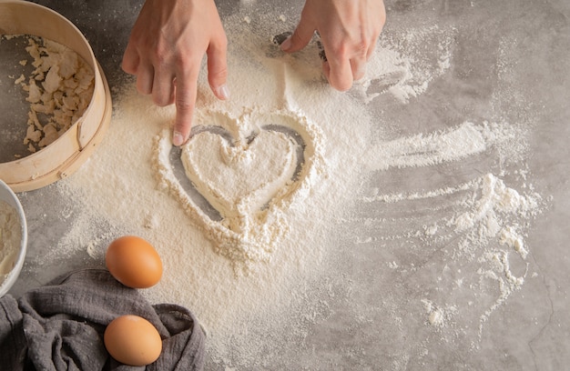 Chef drawing a heart in flour