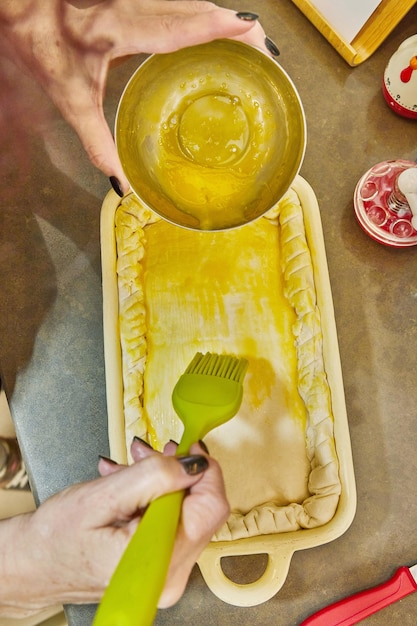 Chef dunks an egg on souffle made from French potatoes zucchini cauliflower and yellow cheese