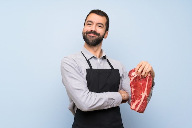 Chef holding a raw meat keeping the arms crossed in frontal position