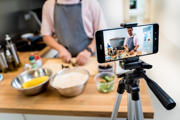 The chef is broadcasting live from workshop how to prepare a vegetarian food