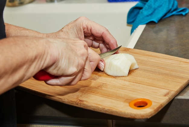 Chef is cutting pear to make pie