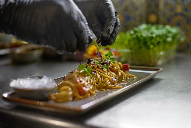 The chef is decorated with fresh herbs and flowers dishes in the restaurant.