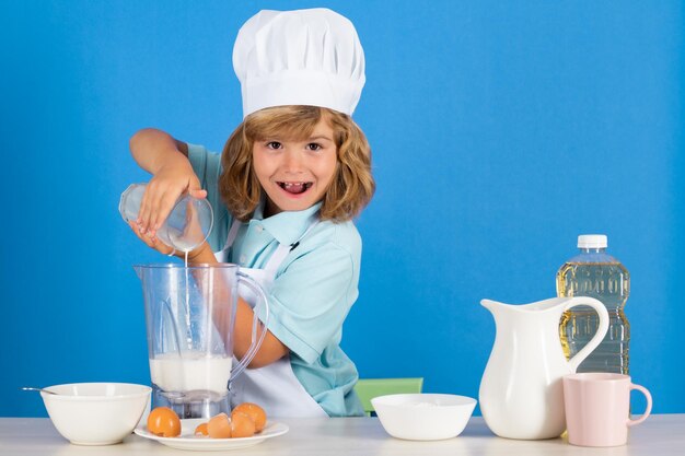 Chef kid boy making fresh vegetables for healthy eat portrait of little child in form of cook isolat