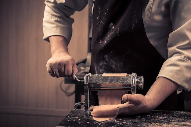 The chef makes fresh spaghetti from scratch