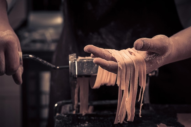 The chef makes fresh spaghetti from scratch