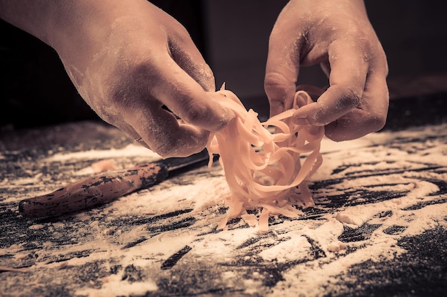 The chef makes fresh spaghetti from scratch