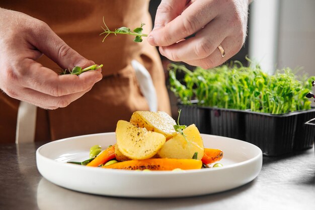 Chef making gourmet dish with microgreens