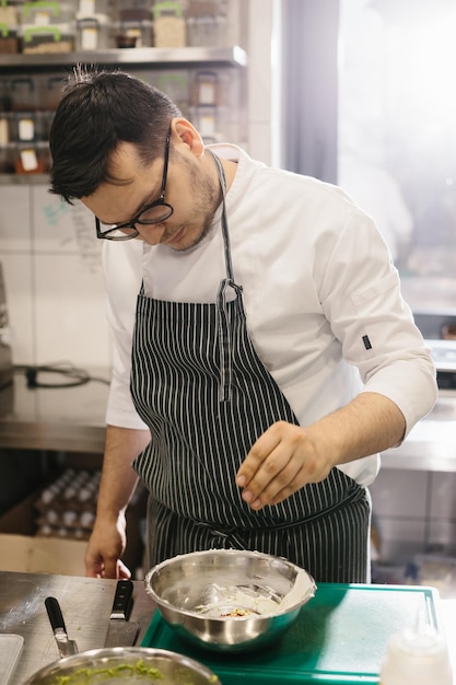 The chef prepares food in the modern spacious kitchen