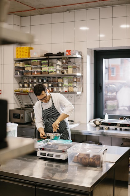 The chef prepares food in the modern spacious kitchen