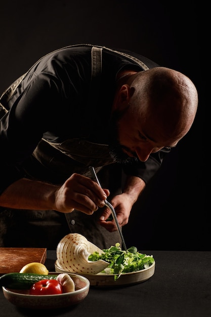 The chef prepares a salad of seafood and vegetables