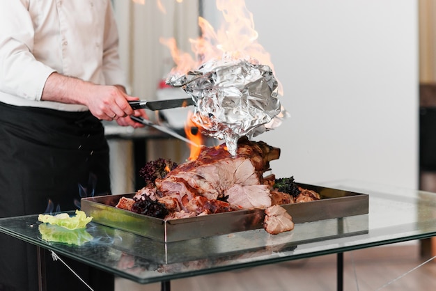 Chef preparing baked Turkey on a platter in the fire. Roast Turkey.