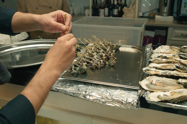 Chef preparing original seafood in restaurant kitchen indoors