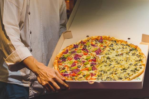 Chef presenting New York style pizzas takeout