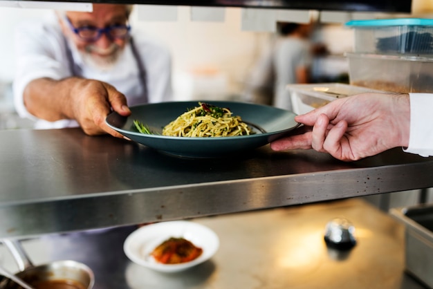 Chef push a food tray to a shelf