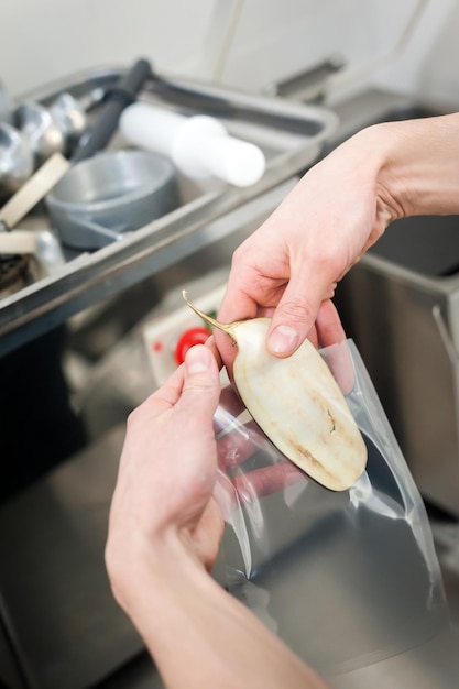 Chef's work on a slicer slicing vegetables