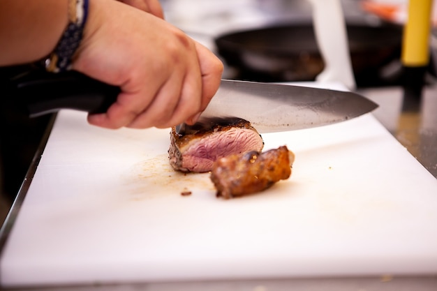 Chef slicing perfect cooked duck breast. Delicious perfect meat