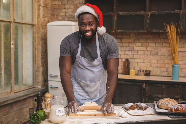 Chef wears apron, prepares dough for making loaf, uses different ingredients, in kitchen