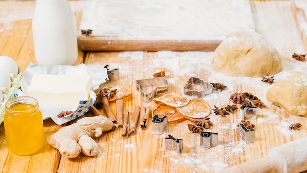 Chef workplace Creative mess on kitchen table Ingredients and tools for making gingerbread biscuits