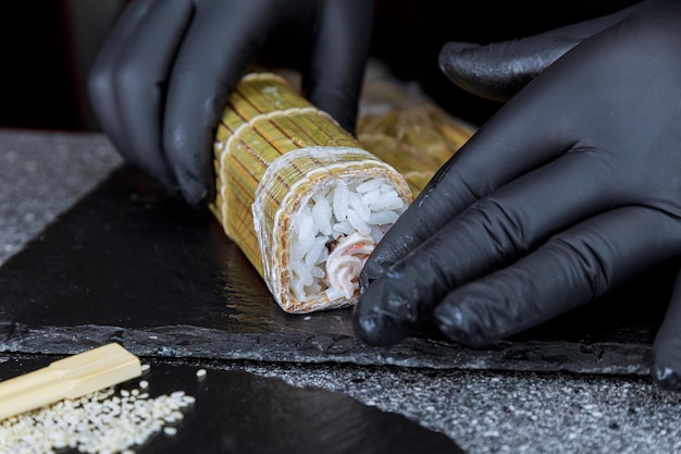 The chef wrapped the sushi roll with a bamboo mat Delicious and satisfying dish