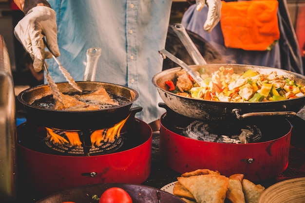 Cheff cooking fusion international cusine on street stall on international street food festival of o...