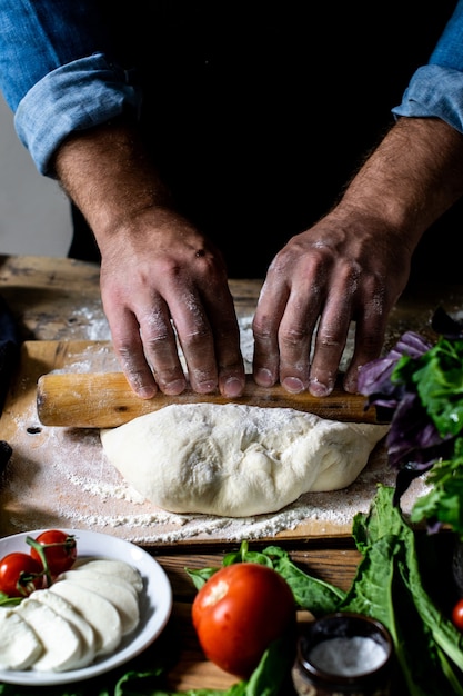 Chefs hands italian chef cooking pizza man hands cooking pizza dough for pizza