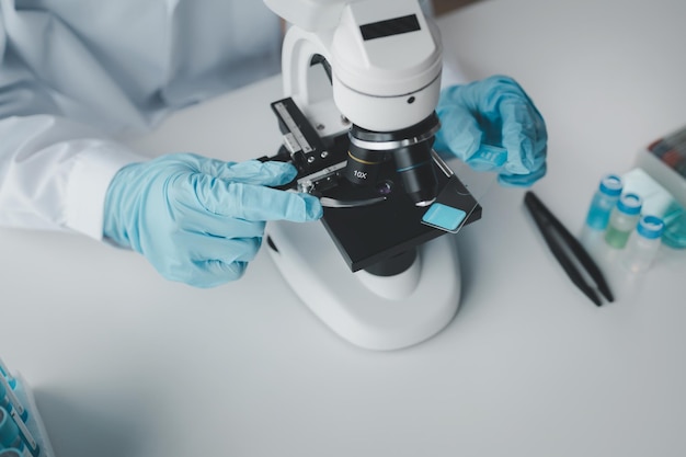 chemist is doing an experiment in the laboratory A scientist is using a microscope to analyze the chemical composition A scientific experiment is searching for biological answers in a laboratory