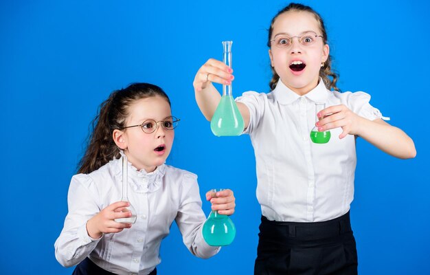 Chemistry fun Knowledge day Schoolgirl with colorful chemical liquids Education concept Safety measures Small kid study Chemistry lesson Having fun with chemistry Educative experiment