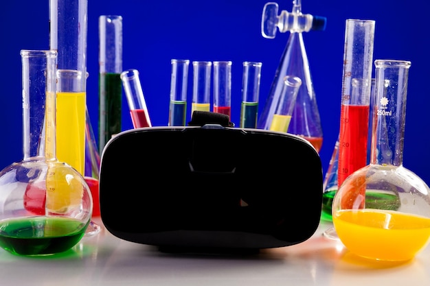 Chemistry lab set on a table with VR headset next to it. Glassware and biology equipment