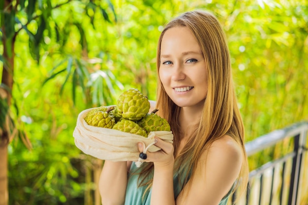 Cherimoya in a reusable bag in female hands zero waste concept plastic free concept healthy clean