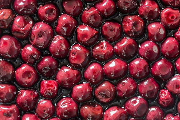 Cherries in alcohol in their own juice close up top view Fresh ripe red cherry soaked in alcohol