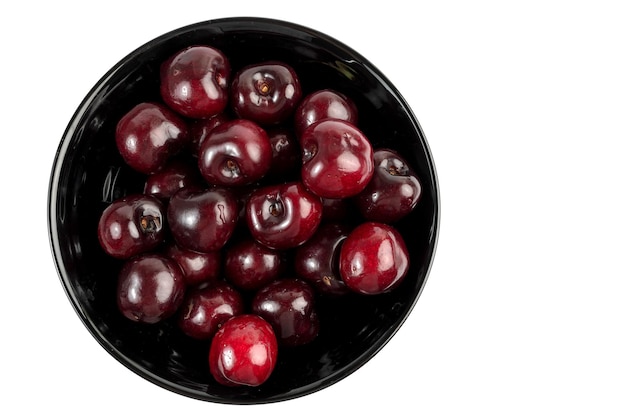 Cherries in a black bowl.